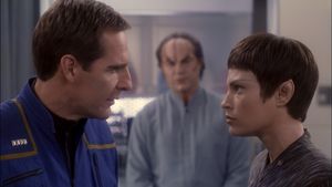 In sickbay, Archer and T'Pol look directly at one another, while Phlox is in the background looking concerned  and out of focus.       