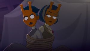 Tendi and T'Lyn are on an away mission to Dilmar III, and so they have Dilmarian orange skin and blue hair, and big blunt horns protruding from their foreheads. They are sitting down, tied up back to back. Tendi looks pretty pissed off