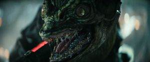 It's a Gorn, a toothy lizard with slit pupils and a slavering mouth full of needle-sharp teeth. It looks like it's roaring angrily.