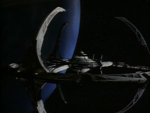 Our first view of Deep Space Nine, a spidery circular space station in orbit around the Earth-like planet of Bajor.