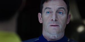 The harshly-lit face of Captain Gabriel Lorca. He eyebrows are arched and his lips are parted: he is about to make Michael Burnham an offer.