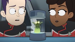 Boimler and Mariner are on either side of a glass specimen cylinder  looking at its contents — a tiny toothy little grub with tiny scythe-like arms. It seems a bit cross about being captured.