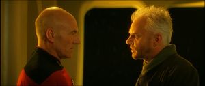 Picard and Soran stand facing each other, lit by sunlight streaming in through the windows of Ten Forward.