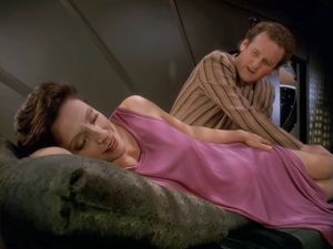 Kira is lying in bed, wearing a nightie that doesn't cover her legs. O'Brien is talking to her and massaging those legs. Kira seems extremely relaxed.