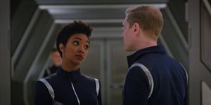 Michael and Stamets are standing in a corridor on Discovery. Michael is giving him a sceptical look.