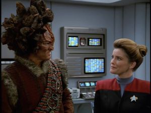 Janeway glances sceptically at Maje Culluh, a Kazon more than a foot taller than her.