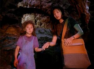 We're in a cave with two Mollys: a little girl with a dirty face who is looking directly at us, wide-eyed. And a young woman holding her hand and looking with some concern in the same direction as the little girl.