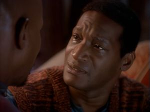The older Jake (Tony Todd) looks up at his father with tears in his eyes.