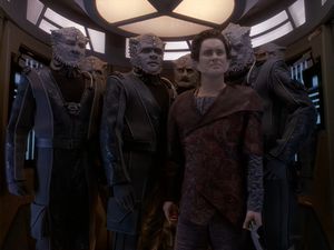 The Defiant's transporter pad is full: six Jem'Hadar, and dwarfed by them, it's Weyoun, looking smug, appearing on DS9 for the first time.