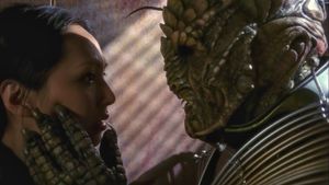 It’s a two-shot. On the left is Hoshi, staring in an unfocused way at the giant Xindi-Reptilian on the right. He’s taller and greener than her, and he’s touching her cheek tenderly with his left hand.